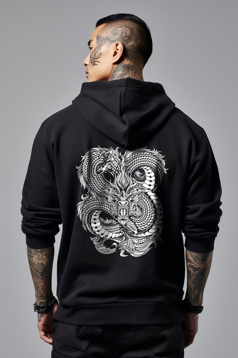 man wearing a black hoodie with a large illustration of a white japanese dragon on the back