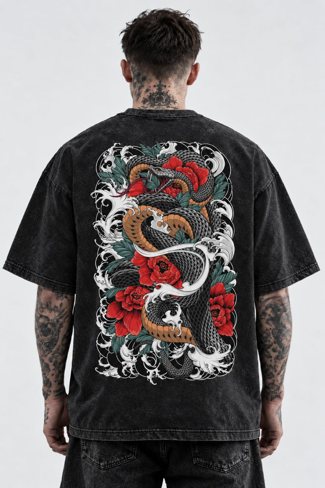 Model wearing a black stonewash Japanese graphic T-shirt with a large snake and red flower back print