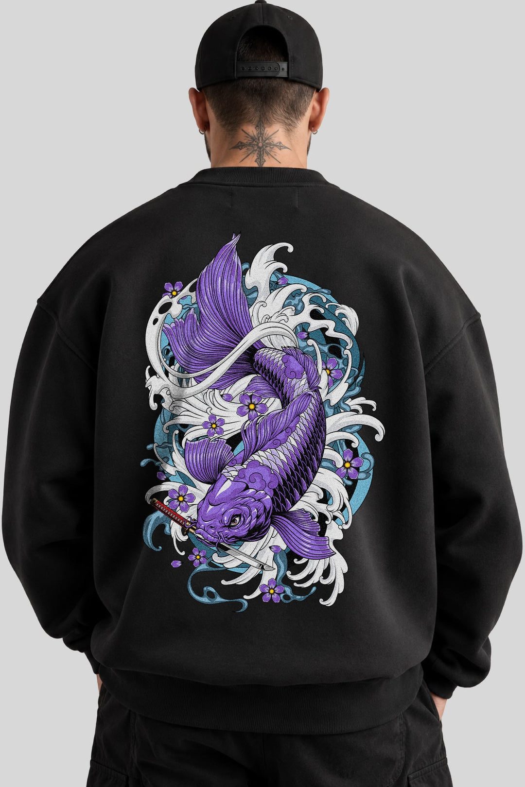 Model wearing black crewneck sweatshirt with large tattoo inspired purple koi fish back print.