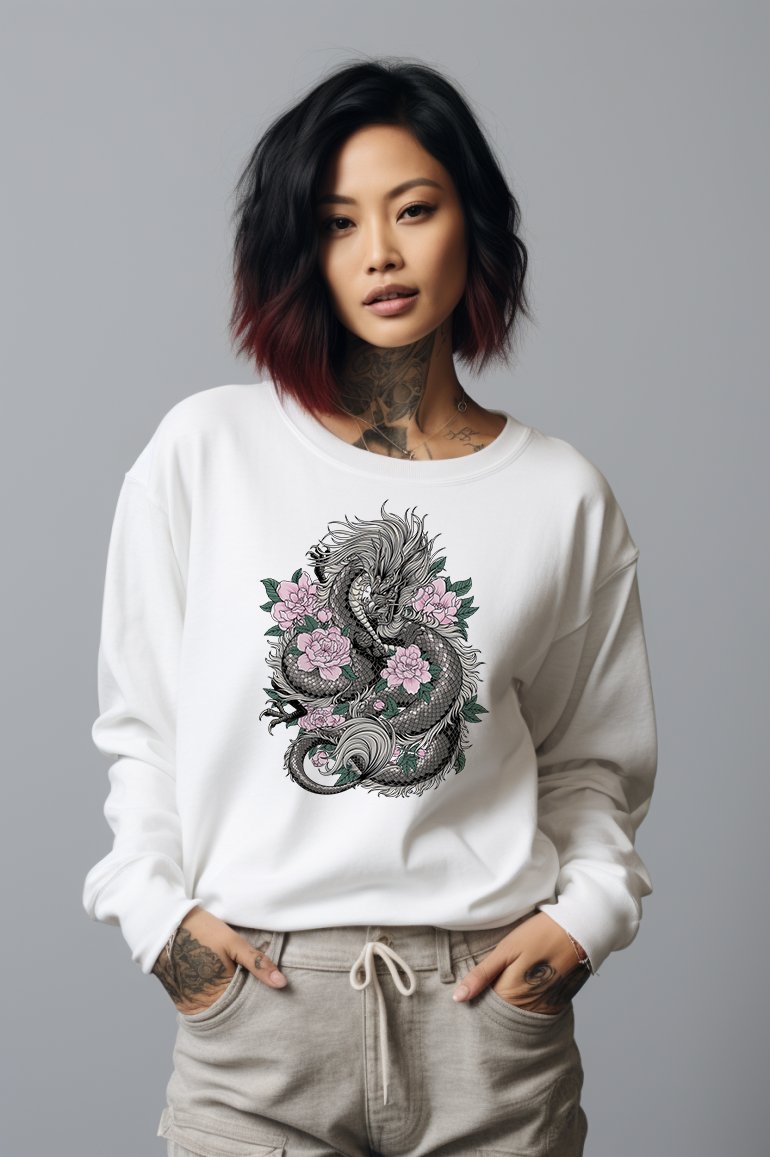 woman wearing a white sweater with a illustration of a dragon surrounded by flowers on the front