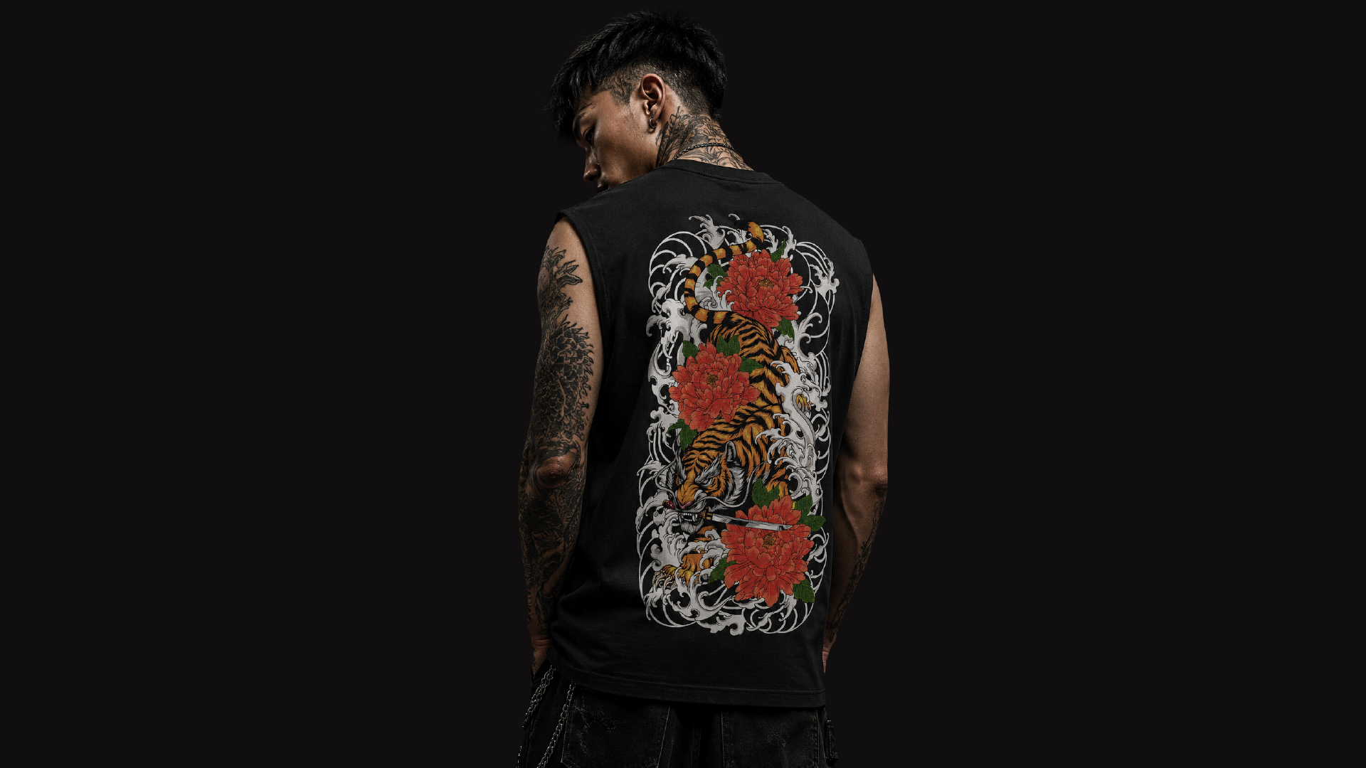 Man wearing black sleeveless shirt with tiger print on the back