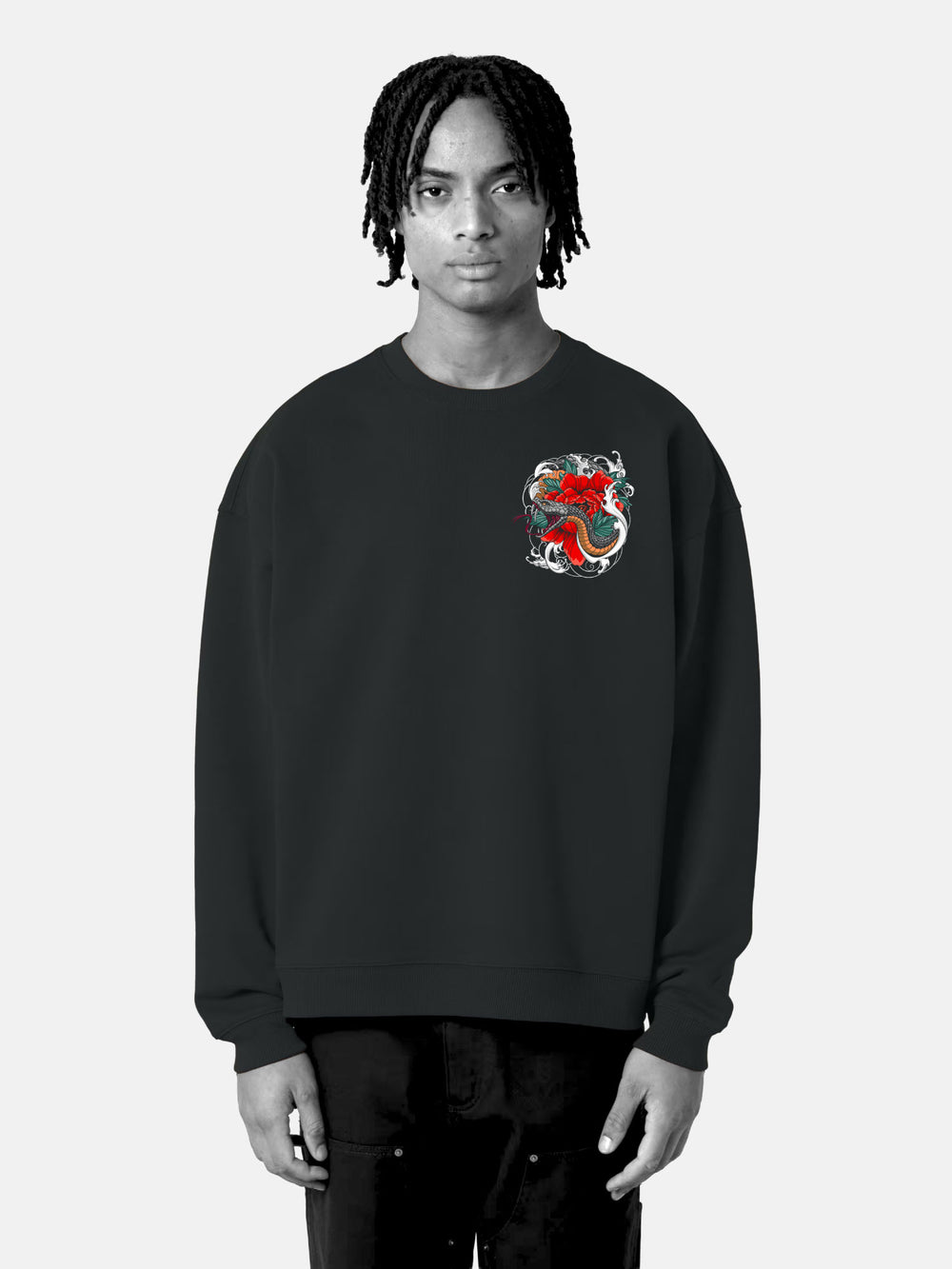 Model wearing black oversized sweatshirt with red serpent and floral left chest tattoo graphic – Serpents Bloom design
