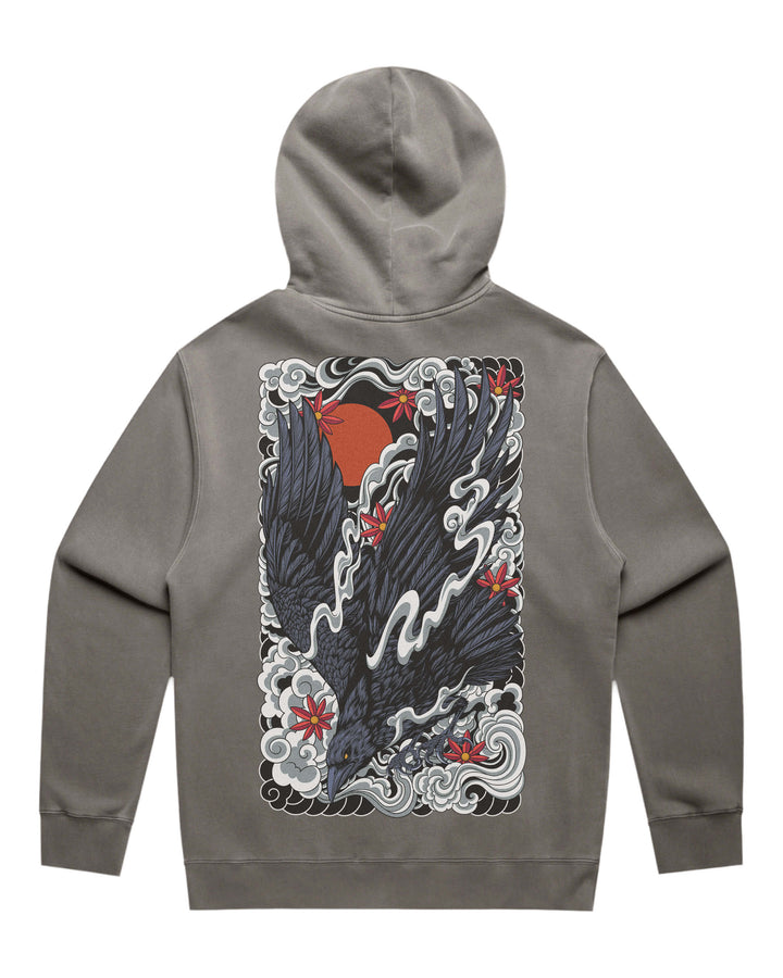 A faded gray pullover hoodie shown from the back, featuring a large graphic print of a black raven with red maple leaves and a red sun over white waves.