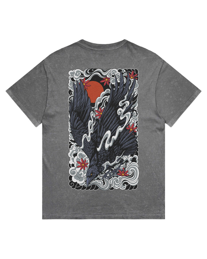 A coal stonewash short-sleeve t-shirt with a large graphic print on the back featuring a black raven, red sun, and red cherry blossoms amidst white waves.