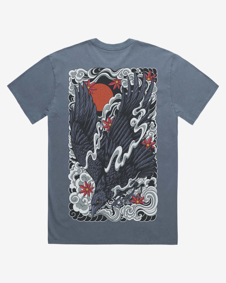 faded indigo graphic t-shirt with a raven and irezumi clouds design on the back against a white background