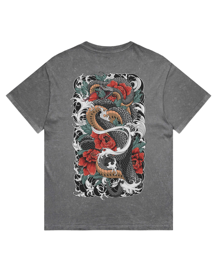 A coal stonewash short-sleeve t-shirt with a large, detailed graphic print on the back featuring a tattoo-style illustration of a black and gold snake wrapped around red roses and white waves.