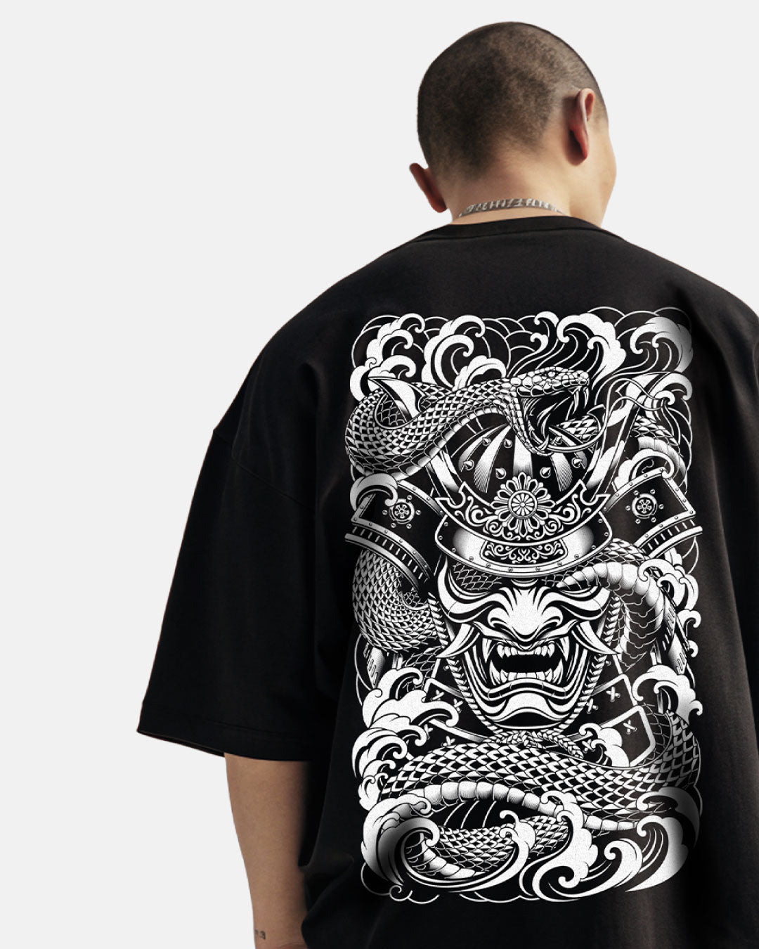Person wearing a black t-shirt with a white dragon and samurai design on the back.