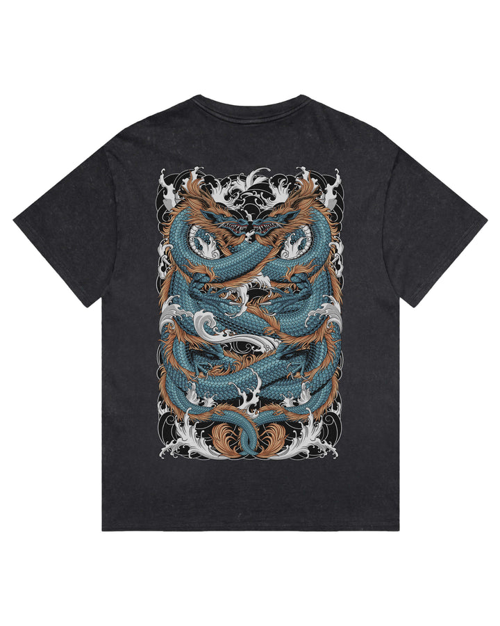 A black stonewash short-sleeve t-shirt with a large graphic print of two intertwined dragons in teal, brown, and white on the front.