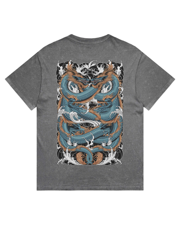 A coal stonewash short-sleeve t-shirt with a large graphic print on the back featuring two stylized blue and brown koi fish swimming through white waves, set against a plain white background.